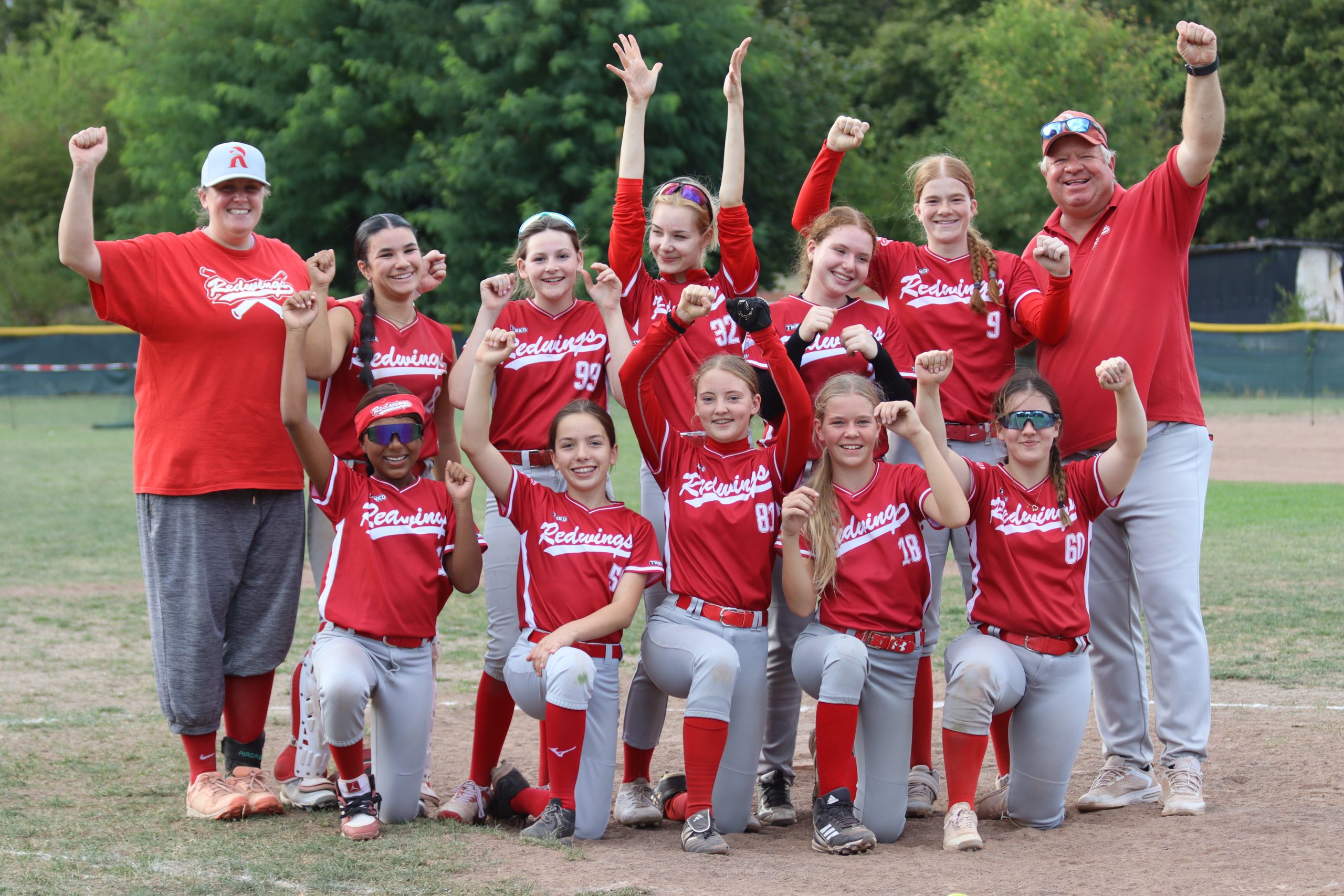 Die U19-Softball-Hessenmeisterinnen der Redwings jubeln mit ihrem Trainerteam