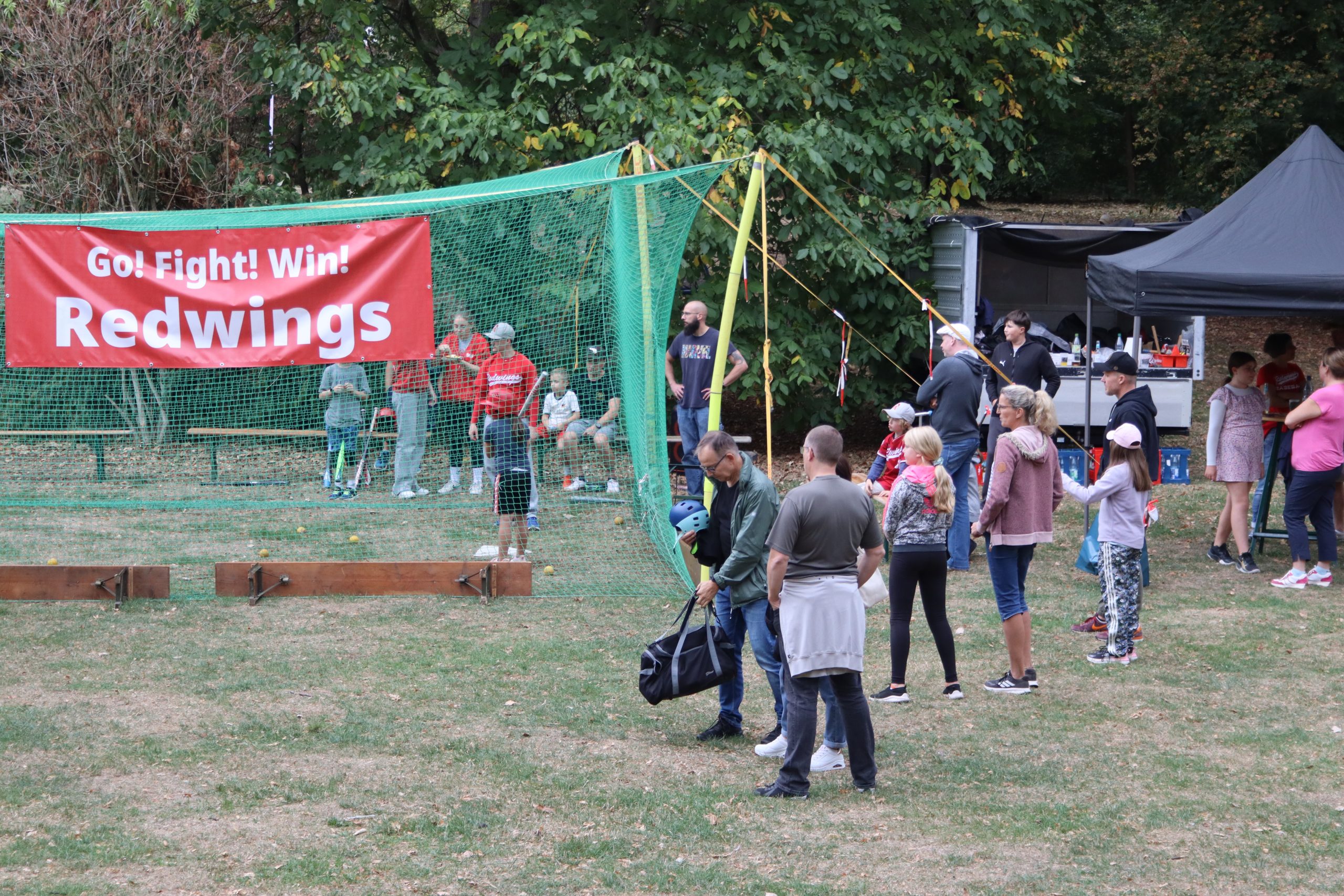 Familien am Redwings-Stand und Batting Cage im Freizeitpark